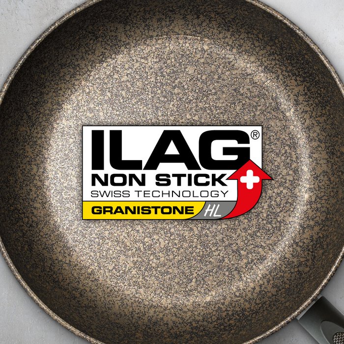 Coated inside of a frying pan with black base and a cover in mat gold - ILAG logo with yellow shaded Granistone HL lettering in the center