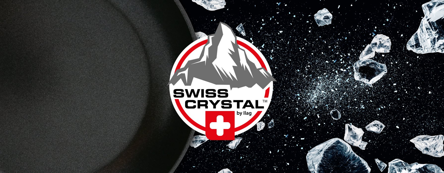 In the background black coated inside of a frying pan and fragments of a smashed crystal. In the foreground on white ground a imitation of the Matterhorn in grey. Swiss crystal lettering in black in the middle and the Swiss Cross underneath. The logo is rounded off with a red frame.